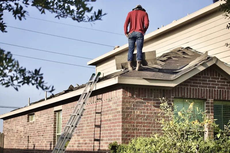 Professional roofer working on a residential roof in Glen Echo Heights